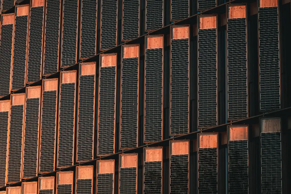 a tall building with lots of windows next to a clock